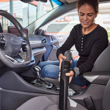 girl vacuuming the car